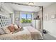 Bedroom with a four-post bed frame, carpeted floors, and a large window with a view at 12409 Gentle Swan Pl, Odessa, FL 33556