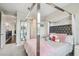 Bedroom with a four-post bed frame, carpeted floors, and a large window at 12409 Gentle Swan Pl, Odessa, FL 33556