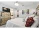 Well-lit bedroom features stylish decor, a decorative dresser, and connecting bathroom entrance at 12409 Gentle Swan Pl, Odessa, FL 33556