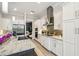Spacious kitchen with stainless steel appliances, island with seating, and stylish cabinetry, perfect for culinary enthusiasts at 12409 Gentle Swan Pl, Odessa, FL 33556