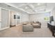 Bright living room showcasing a comfortable sectional, coffered ceilings, and neutral tones at 12409 Gentle Swan Pl, Odessa, FL 33556