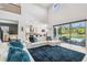 Bright open-concept living room with an amazing view of the outdoor pool and living area at 12409 Gentle Swan Pl, Odessa, FL 33556