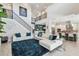 Open-concept living room boasts a high ceiling, modern staircase, and views of the kitchen at 12409 Gentle Swan Pl, Odessa, FL 33556