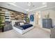 Spacious bedroom with wood-accent wall, plush carpet, and modern furnishings at 12409 Gentle Swan Pl, Odessa, FL 33556