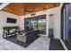 Screened-in outdoor living area with comfortable seating and a heater for year-round enjoyment at 12409 Gentle Swan Pl, Odessa, FL 33556