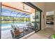 The covered patio offers an outdoor living space with a pool and lake view at 12409 Gentle Swan Pl, Odessa, FL 33556
