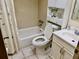 Bathroom featuring a shower-tub combo, vanity, and built-in shelving for storage at 1257 Drew St # 8, Clearwater, FL 33755