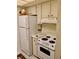 Cozy kitchen with classic white appliances and cabinets, creating a clean and efficient space at 1257 Drew St # 8, Clearwater, FL 33755
