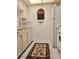 Functional kitchen space includes white appliances and a decorative rug adding warmth to the room at 1257 Drew St # 8, Clearwater, FL 33755