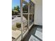 View from the enclosed porch featuring an exterior stairwell and landscaping at 1257 Drew St # 8, Clearwater, FL 33755