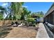 Landscaped backyard featuring a fire pit, seating area, and lush greenery for outdoor relaxation and entertaining at 1655 Owen Dr, Clearwater, FL 33759
