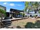 Backyard with patio, pergola, grill, dining set, plants, and a well-maintained lawn at 1655 Owen Dr, Clearwater, FL 33759