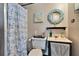 The bathroom is equipped with a toilet, sink, mirror and decorative wall pieces at 1655 Owen Dr, Clearwater, FL 33759