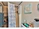 This bathroom has a toilet, shower, decorative wall art, and essential storage at 1655 Owen Dr, Clearwater, FL 33759