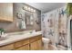 The bathroom featuring a nautical-themed shower curtain, a sink, a toilet and decorative pieces at 1655 Owen Dr, Clearwater, FL 33759