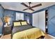 Comfortable bedroom featuring a ceiling fan, a wooden floor and a large window at 1655 Owen Dr, Clearwater, FL 33759
