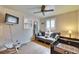This bedroom features a sofa, two windows, and a ceiling fan with cozy décor at 1655 Owen Dr, Clearwater, FL 33759