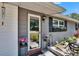 Inviting home entrance with lovely potted plants and a modern glass door at 1655 Owen Dr, Clearwater, FL 33759