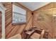 Charming home office with wood paneling, large window, and functional desk space at 1655 Owen Dr, Clearwater, FL 33759