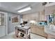 Bright kitchen featuring light wood cabinets, neutral countertops, and a rolling island at 1655 Owen Dr, Clearwater, FL 33759