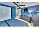 Comfortable main bedroom featuring navy blue walls, a ceiling fan, and an ensuite bathroom at 1655 Owen Dr, Clearwater, FL 33759