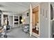 The sunroom features seating arrangements, an exterior door, and an adjoining bathroom at 1655 Owen Dr, Clearwater, FL 33759