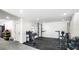 Finished basement with home gym equipment and rubber flooring provides a dedicated workout space at 1725 Massachusetts Ne Ave, St Petersburg, FL 33703