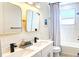 Modern bathroom with dual sinks, gold fixtures, a freestanding tub, and a stylish shower at 1725 Massachusetts Ne Ave, St Petersburg, FL 33703