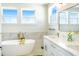 Bright bathroom with a soaking tub, dual vanities, and modern fixtures at 1725 Massachusetts Ne Ave, St Petersburg, FL 33703