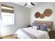 Cozy bedroom with a queen bed, neutral tones, natural accents and a ceiling fan at 1725 Massachusetts Ne Ave, St Petersburg, FL 33703