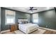 Stylish bedroom with a queen bed, rich green walls, and natural wood furniture at 1725 Massachusetts Ne Ave, St Petersburg, FL 33703