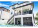 Exterior of home with a second story balcony and an outdoor kitchen at 1725 Massachusetts Ne Ave, St Petersburg, FL 33703