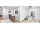Bright, modern hallway with white walls, wood floors, iron railings, and a cozy reading nook at 1725 Massachusetts Ne Ave, St Petersburg, FL 33703