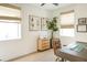 Bright home office with a wooden desk, neutral decor, natural light, and hardwood floors at 1725 Massachusetts Ne Ave, St Petersburg, FL 33703