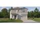 Charming two-story home with gray siding, a two-car garage, and a beautifully landscaped front yard at 17605 Happytrails St, Land O Lakes, FL 34638