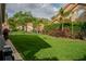 Expansive backyard featuring lush greenery, mature landscaping, and a view of neighboring homes at 18919 Place Marquette, Lutz, FL 33558