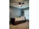 Stylish bedroom with a dark wood bed frame, neutral decor, and natural light from the window at 18919 Place Marquette, Lutz, FL 33558
