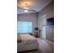 Comfortable bedroom features a ceiling fan, natural light from the window, and a workspace area at 18919 Place Marquette, Lutz, FL 33558