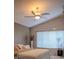 Cozy bedroom featuring a ceiling fan, soft natural light from a window, and comfortable bedding at 18919 Place Marquette, Lutz, FL 33558