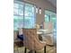Charming dining area with tufted chairs, glass table, and contemporary pendant lights near the bright window at 18919 Place Marquette, Lutz, FL 33558
