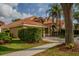 Beautiful exterior view of a single-Gathering home with lush greenery and a well-manicured lawn at 18919 Place Marquette, Lutz, FL 33558