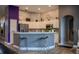 Modern kitchen with white cabinetry, stainless steel appliances, and a stylish breakfast bar at 18919 Place Marquette, Lutz, FL 33558