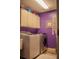 Compact laundry room with modern washer and dryer, plus overhead storage at 18919 Place Marquette, Lutz, FL 33558