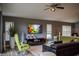 Spacious living room boasts a modern ceiling fan, entertainment center, and comfortable leather seating at 18919 Place Marquette, Lutz, FL 33558
