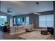 Open concept living area with stylish furnishings, modern lighting, and large windows for ample natural light at 18919 Place Marquette, Lutz, FL 33558