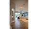 Bright and airy living space featuring wood-look tile, modern decor, and seamless flow to outdoor living areas at 18919 Place Marquette, Lutz, FL 33558