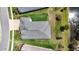 Aerial view showcasing the house, green lawn, and pond, providing a great sense of its surroundings at 19624 Lonesome Pine Dr, Land O Lakes, FL 34638