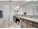 Spacious bathroom with double vanity, granite countertops, and tile floors at 19624 Lonesome Pine Dr, Land O Lakes, FL 34638