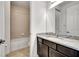 Bathroom featuring a marble vanity, an undermount sink, dark cabinets, a mirror, and a bath tub at 19624 Lonesome Pine Dr, Land O Lakes, FL 34638