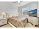 Bright bedroom with a ceiling fan, a window letting in natural light, and a cream dresser with a TV at 19624 Lonesome Pine Dr, Land O Lakes, FL 34638